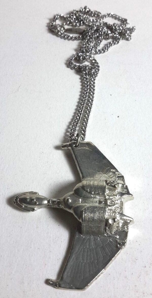 Silver spaceship necklace with chain.