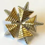 Gold and silver six-pointed star pin.