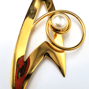 Gold brooch with pearl and star shape.