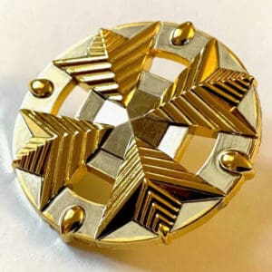 Gold and silver star-shaped pin.