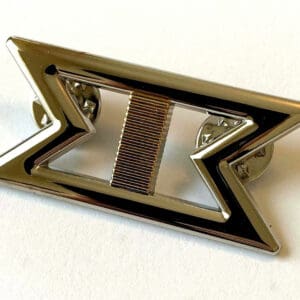 Silver pin with double chevron design.