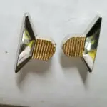 Two silver and gold triangular earrings.