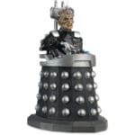 Black and silver Dalek figurine with a figure.