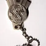 Silver necklace with Doctor Who symbol pendant.