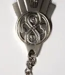 Silver keychain with a Doctor Who symbol.