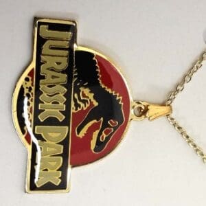 Gold Jurassic Park dinosaur pendant necklace.