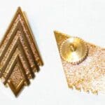 Gold diamond-shaped military rank insignia.