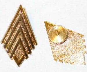Gold diamond-shaped military rank insignia.