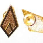 Gold diamond-shaped pin with back view.