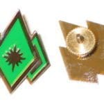 Green diamond with a star pin badge.