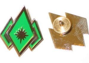 Green diamond with a star pin badge.