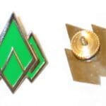 Green diamond-shaped pin with a gold back.