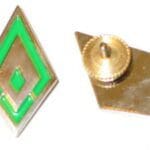 Green diamond shaped badge with pin back.