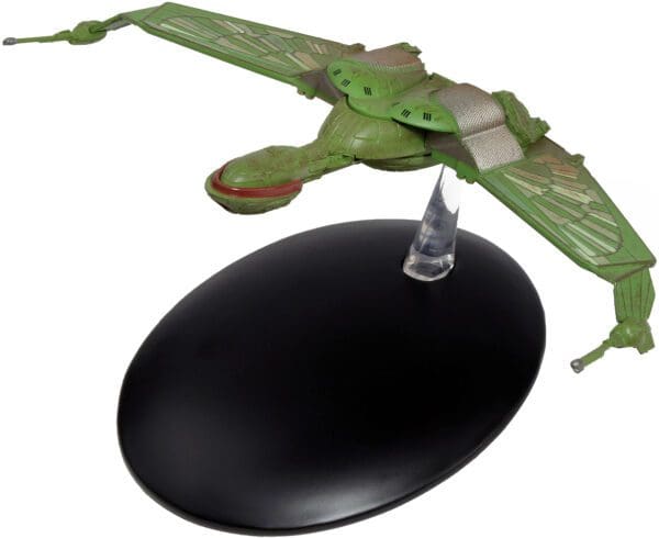 Green-and-gold model of a Denobulan ship on a black base.