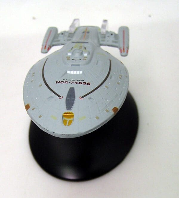 USS Voyager starship model on a base.