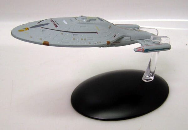 Star Trek model starship on display stand.