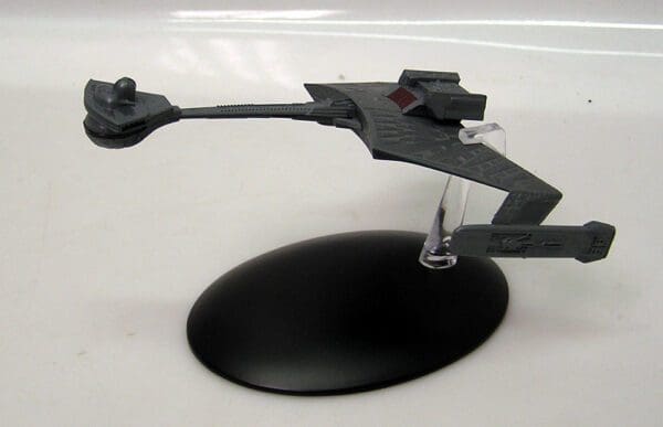 Gray Star Trek ship model on a stand.