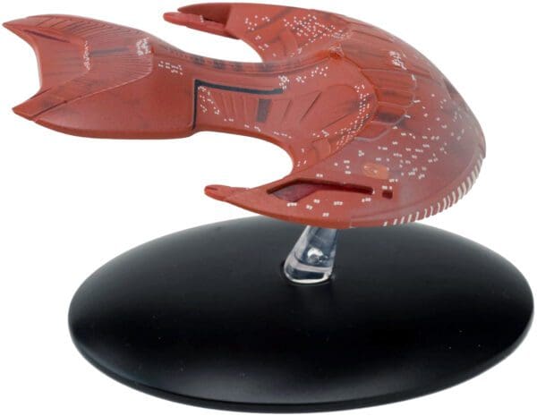 Red Starfleet ship on display stand.