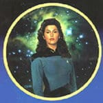 Woman in Starfleet uniform against starry background.