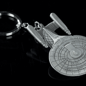 Star Trek Enterprise keychain on black background.