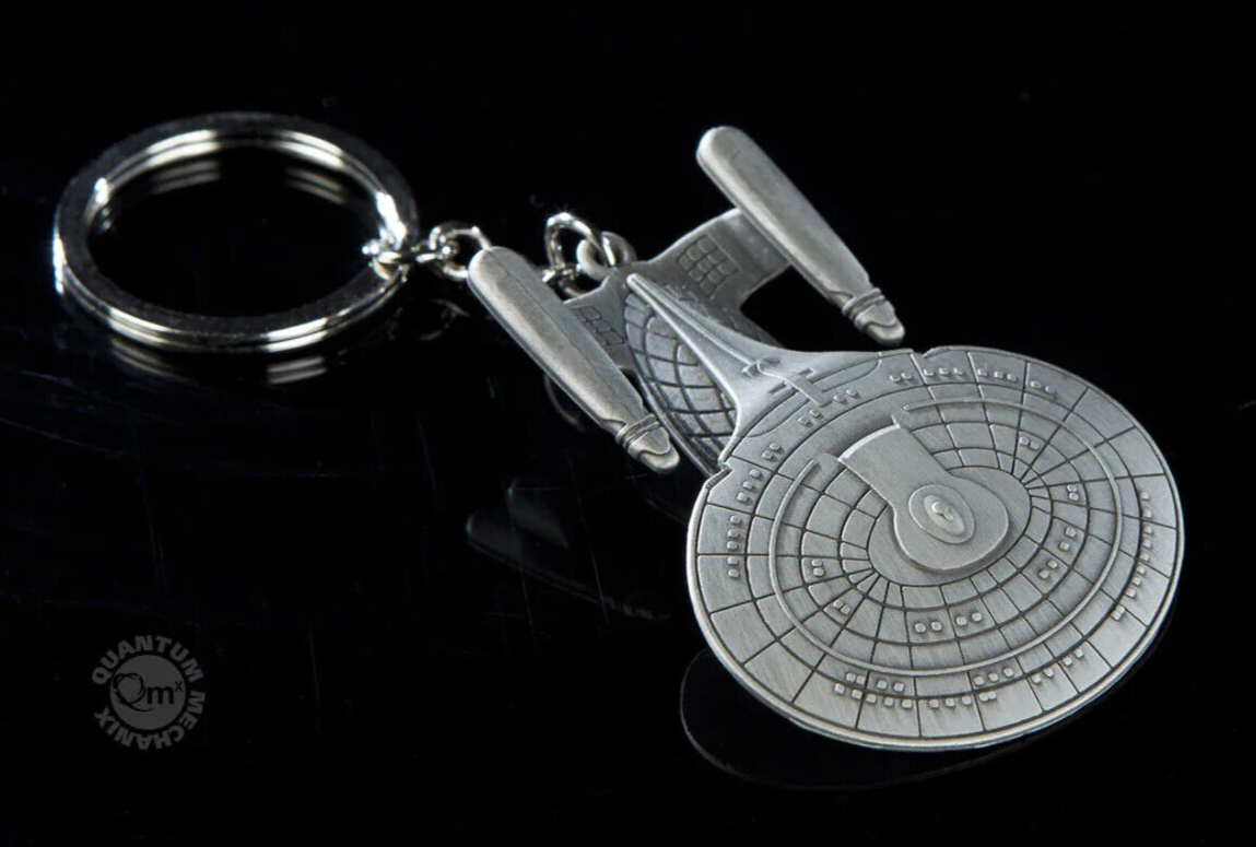 Star Trek Enterprise keychain on black background.
