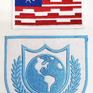 Two embroidered patches with a globe design.