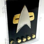 Star Trek insignia in display case with pins.