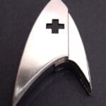 Silver Star Trek insignia with a cross cutout.