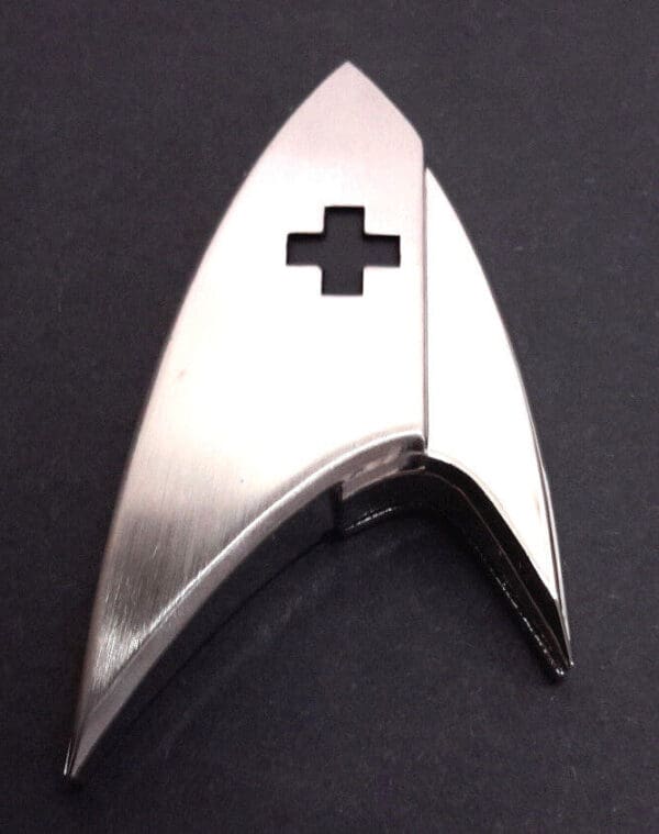 Silver Star Trek insignia with a cross cutout.