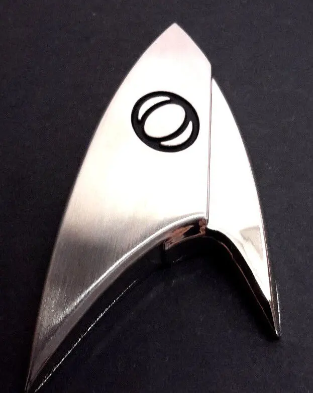 Silver Star Trek delta shaped badge.