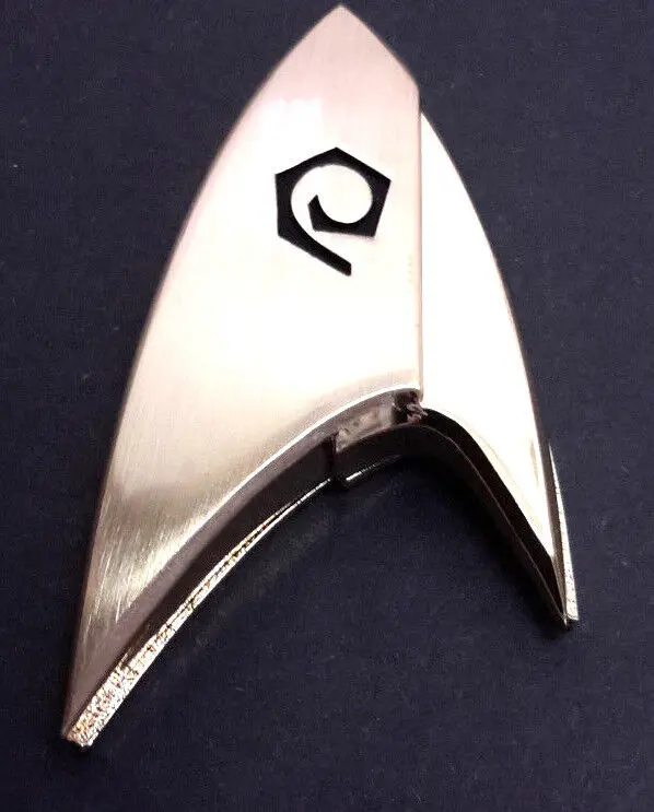 Silver Starfleet insignia with delta symbol.