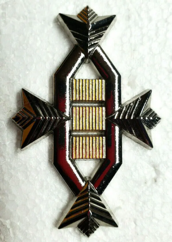 Silver and gold geometric badge with arrows.