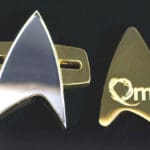 Gold and silver Starfleet insignia pins.