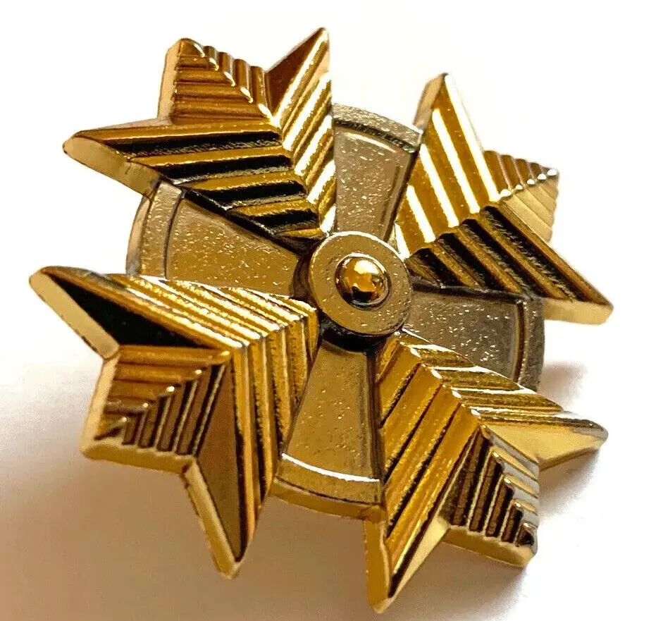 Gold star pin with a center circle.