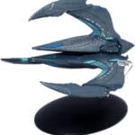 A grey and blue starship model on a stand.