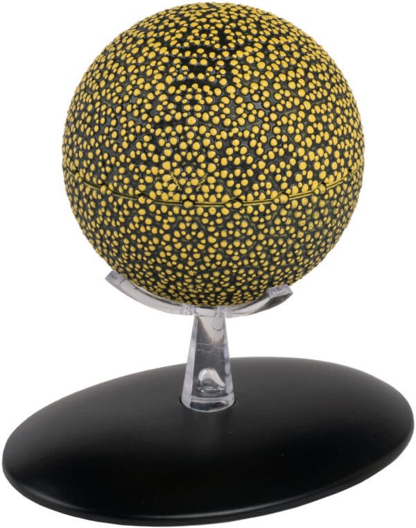 Yellow and black speckled sphere on stand.