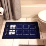 Blue TARDIS bathroom rug with white squares.