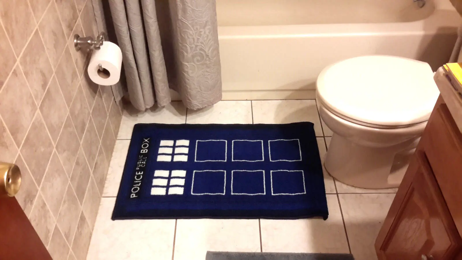 Blue TARDIS bathroom rug with white squares.