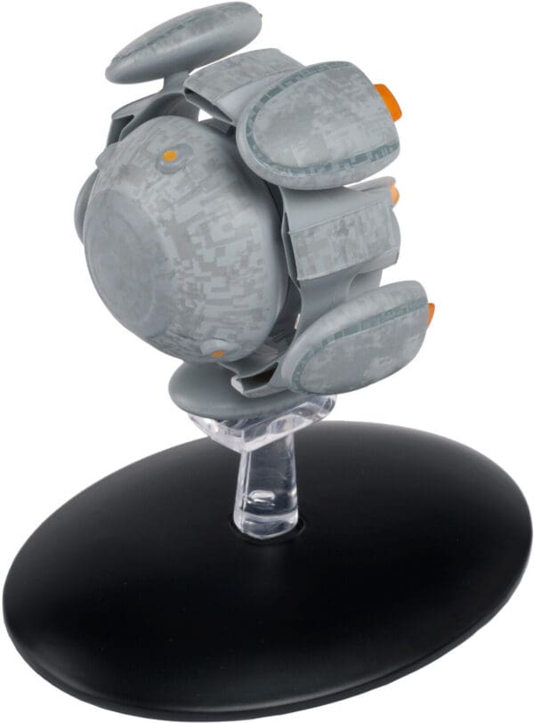 Gray and orange spaceship model on stand.