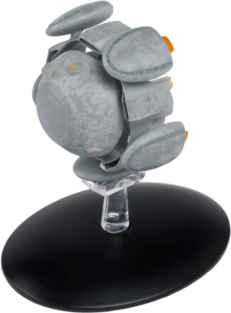 Gray and orange spaceship model on stand.