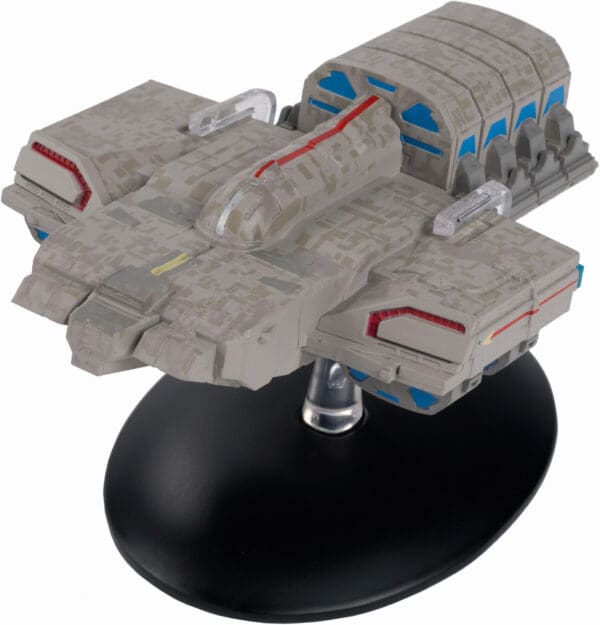 Gray and blue spaceship model on stand.