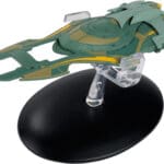 Green and yellow Starfleet ship on a stand.