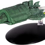 Green Star Trek starship model on stand.