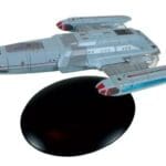 Star Trek: Voyager model starship on stand.