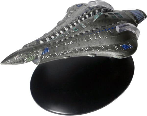 A grey and blue spaceship model on a stand.