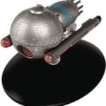 Silver spaceship model on a black base.