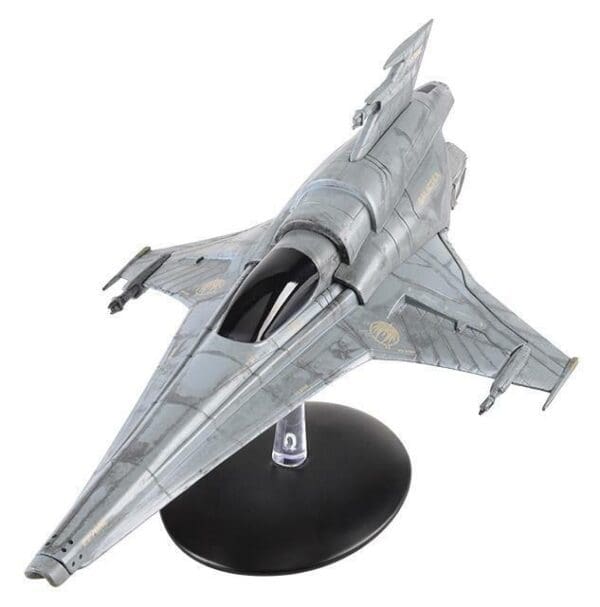 Gray and white starfighter model on stand.