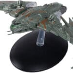 Green-colored Star Trek starship on a base.