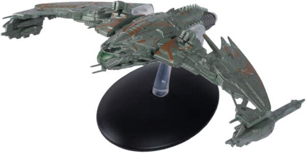 Green-colored Star Trek starship on a base.