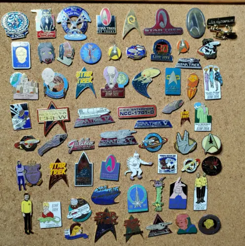 Star Trek enamel pins on cork board.